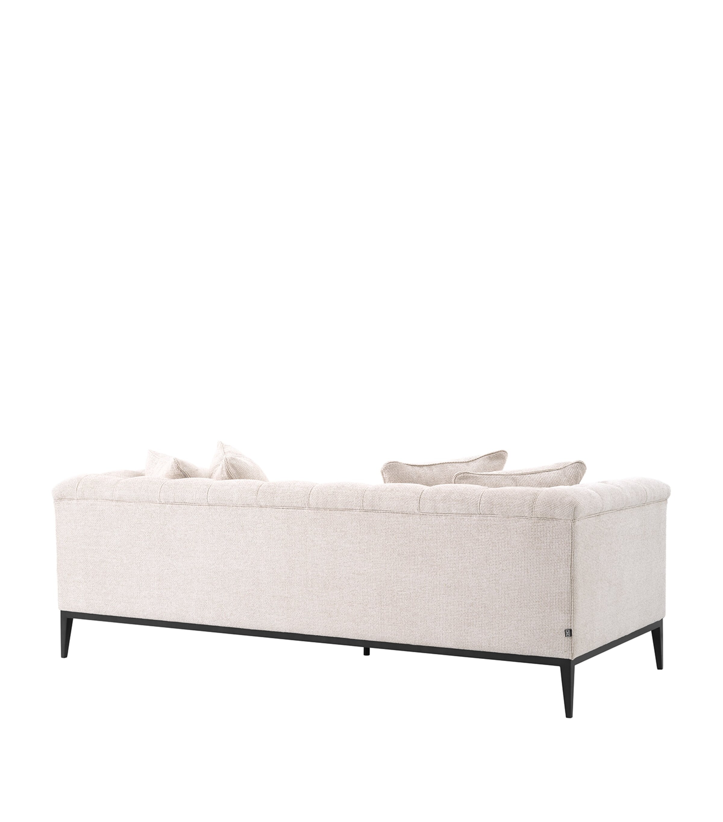 Beige tufted sofa back view showing upholstery and legs