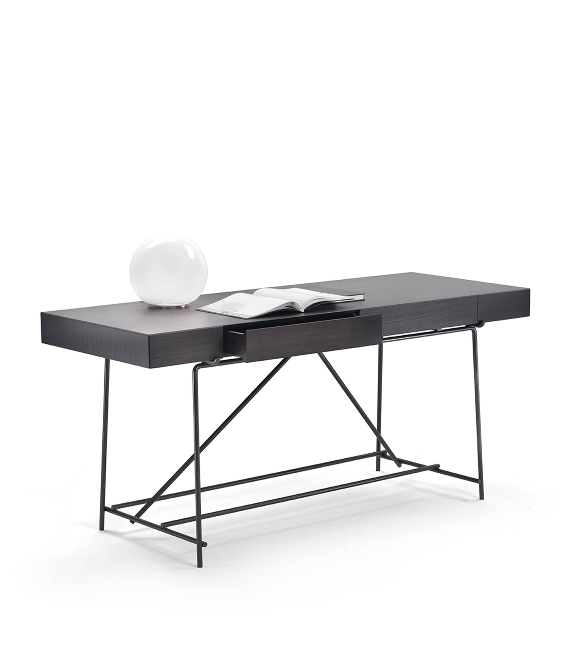 Desk with open book and round decorative object, front view