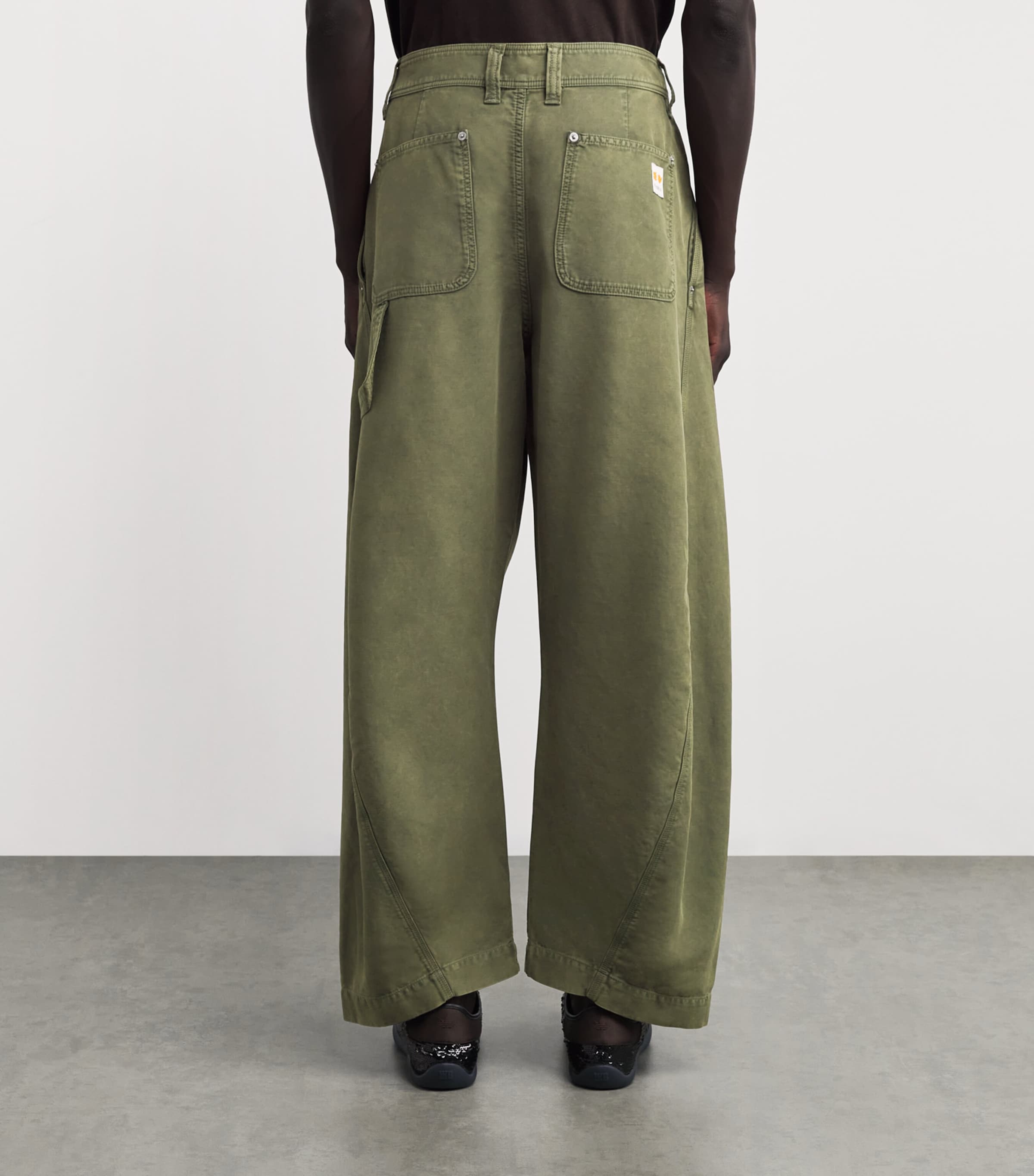 JW Anderson Green Cotton Twisted Seam Trousers | Harrods UK