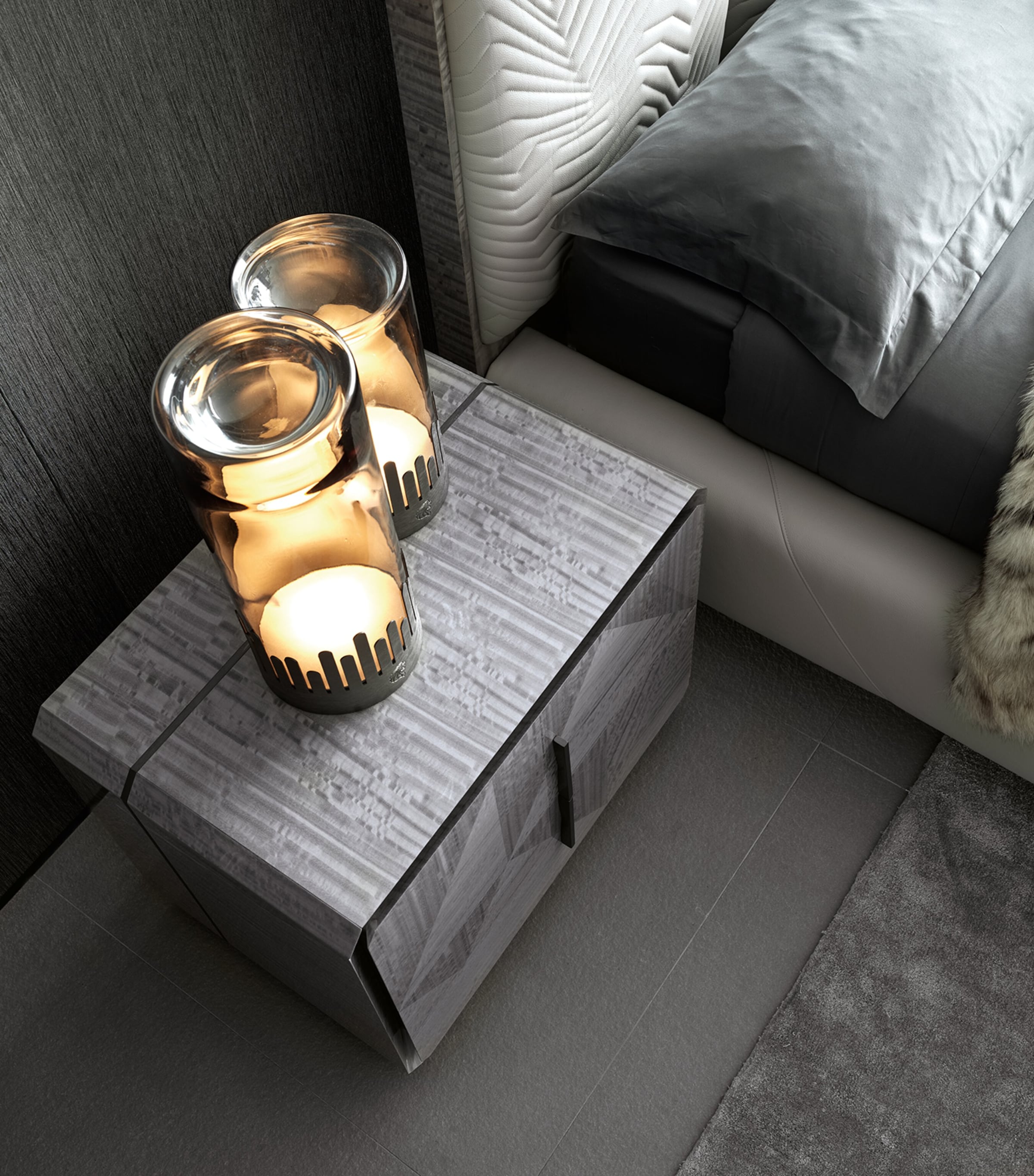 Moonlight bedside table with candles and bed view
