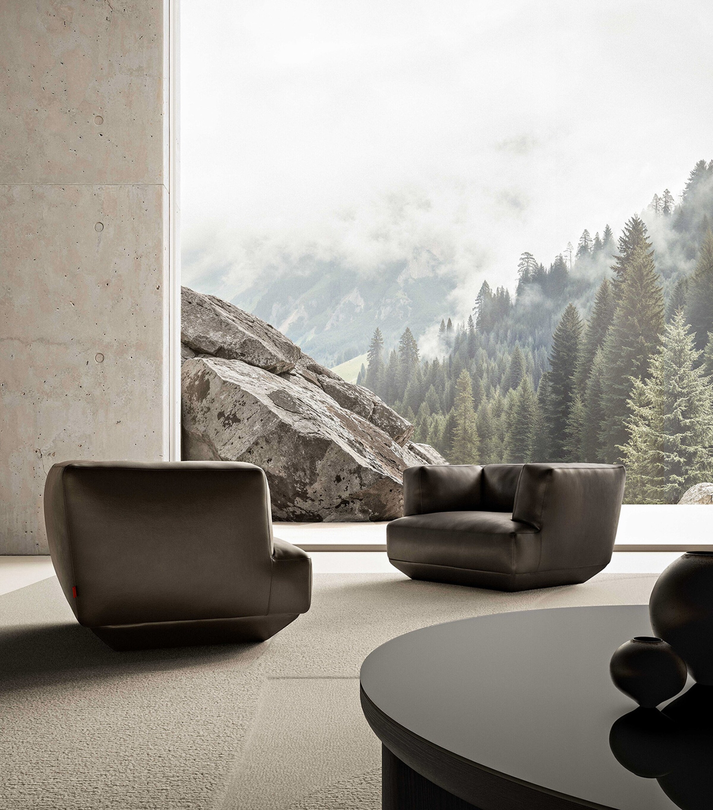 Three dark grey lounge chairs in a modern showroom