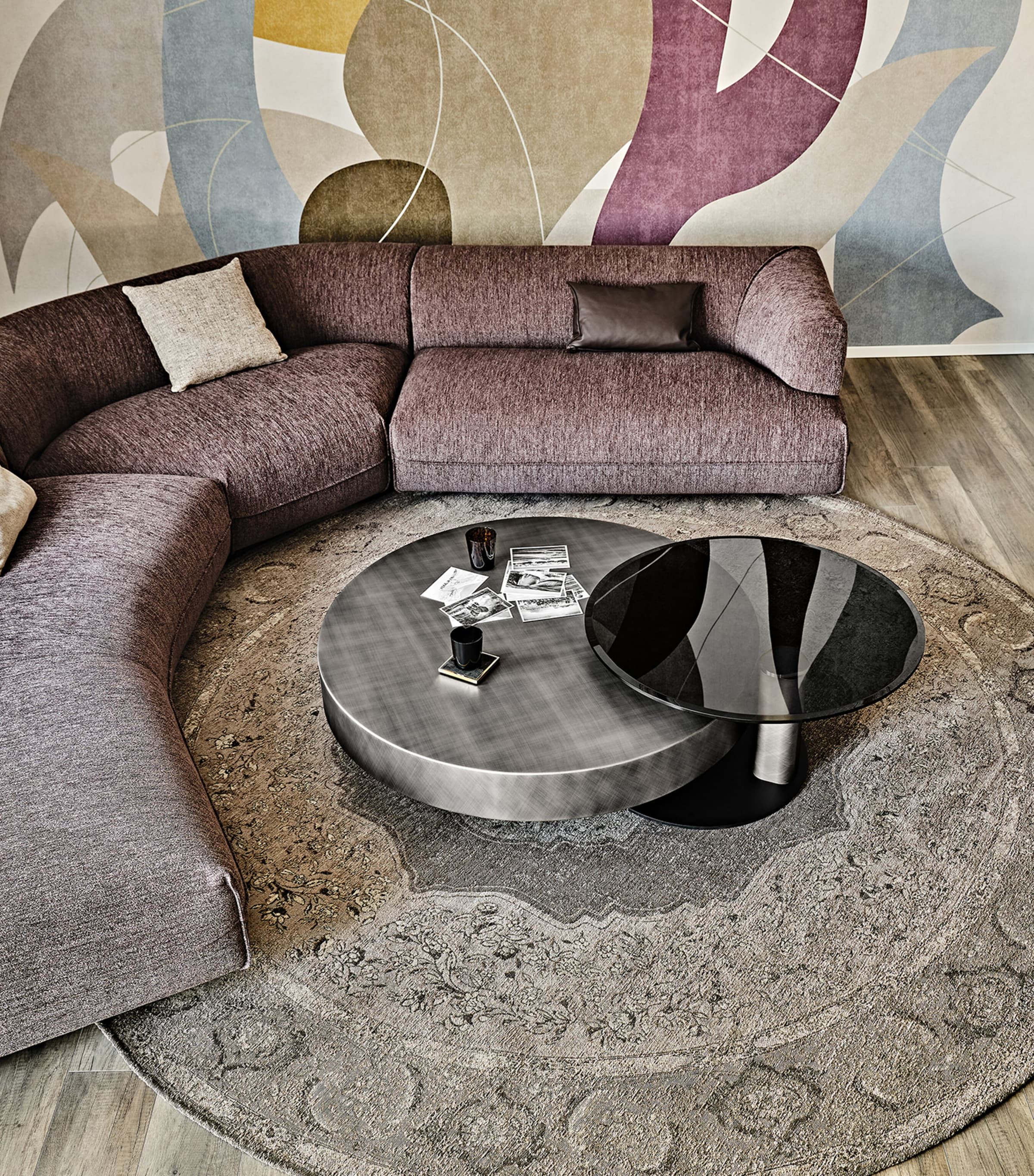 Modern lounge with curved sofa and two round coffee tables