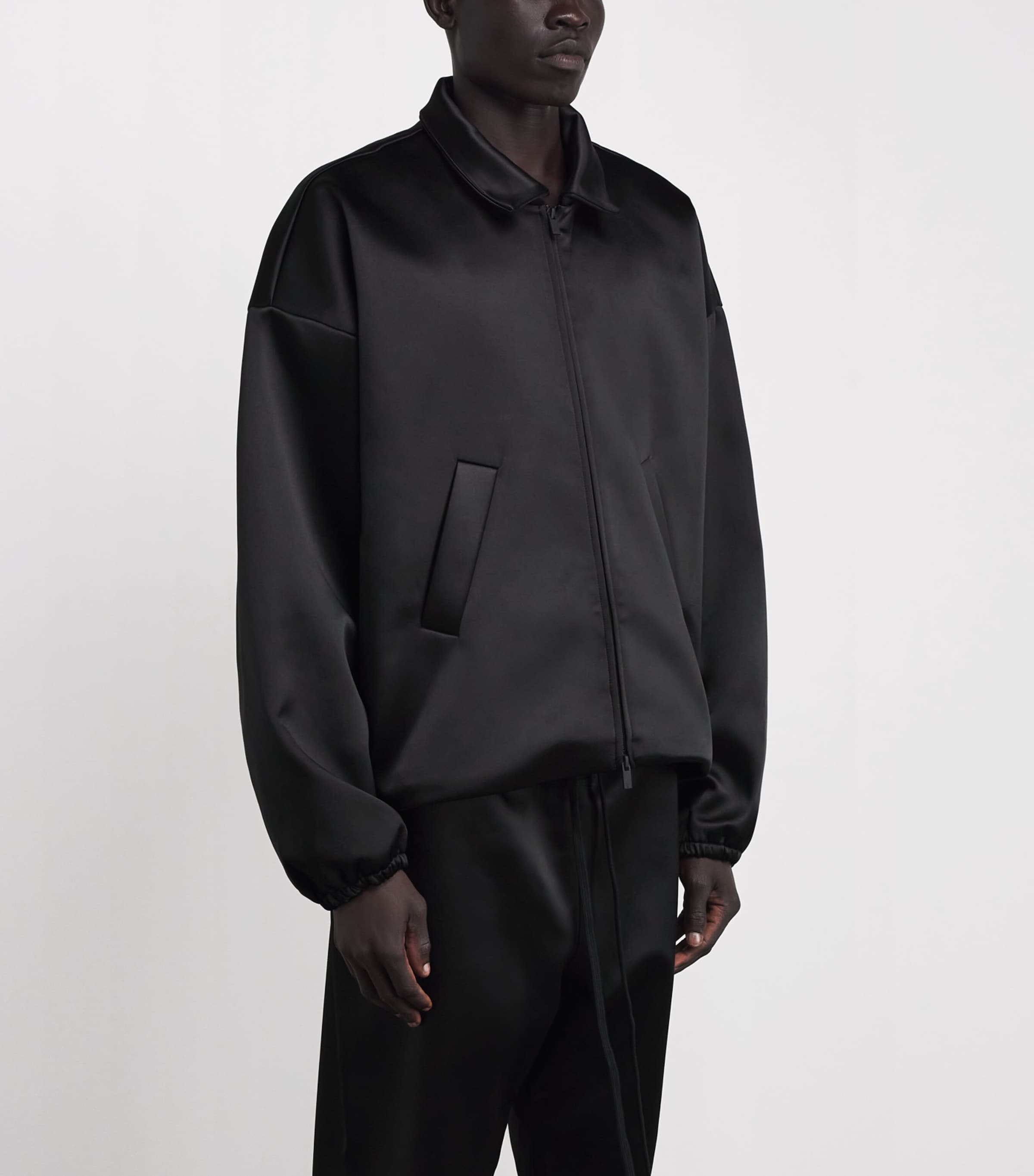 FEAR OF GOD ESSENTIALS Black Bonded Satin Bomber Jacket | Harrods US