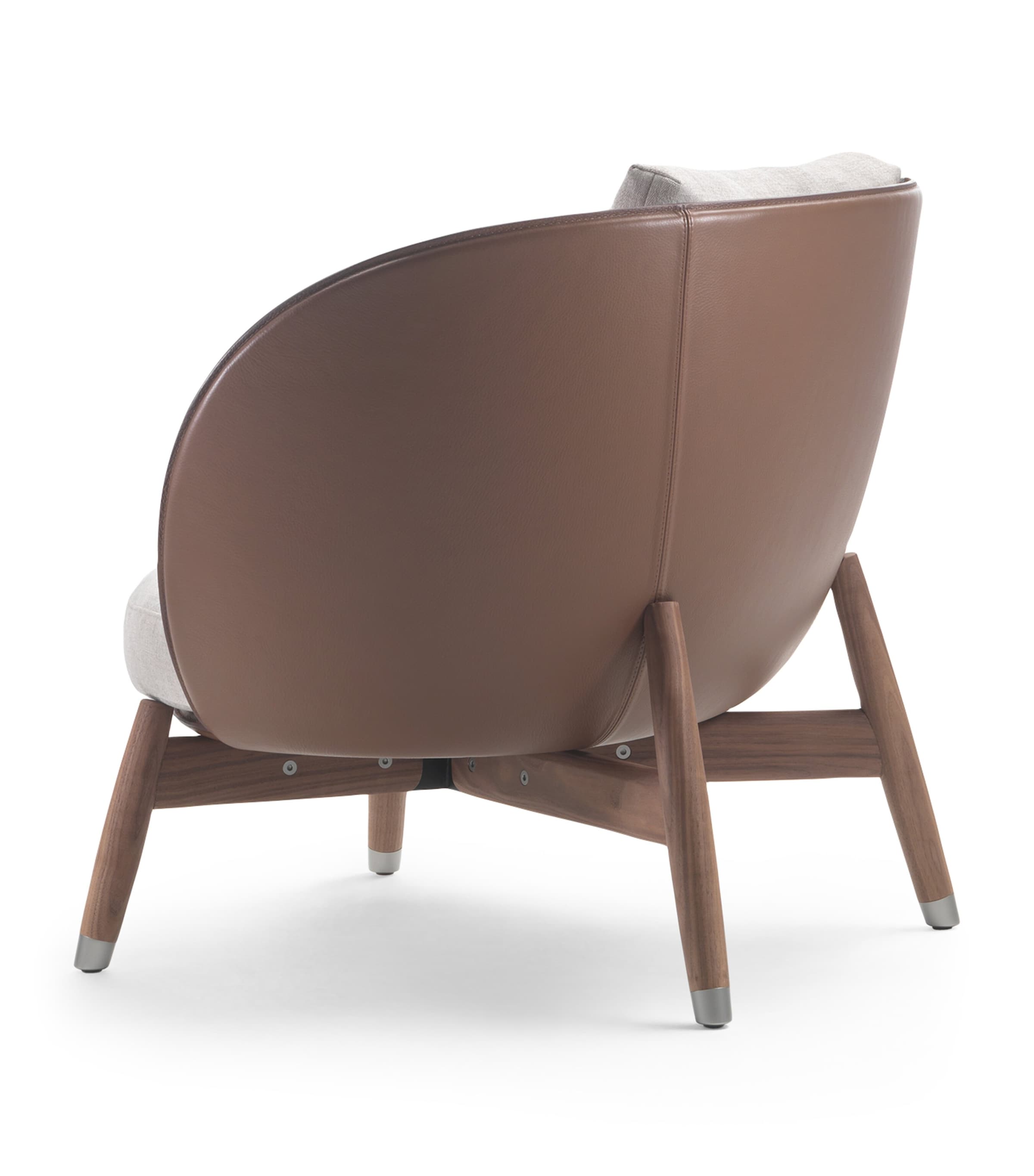 Rear/side view of Flexform Eri armchair highlighting curved leather back and wooden legs