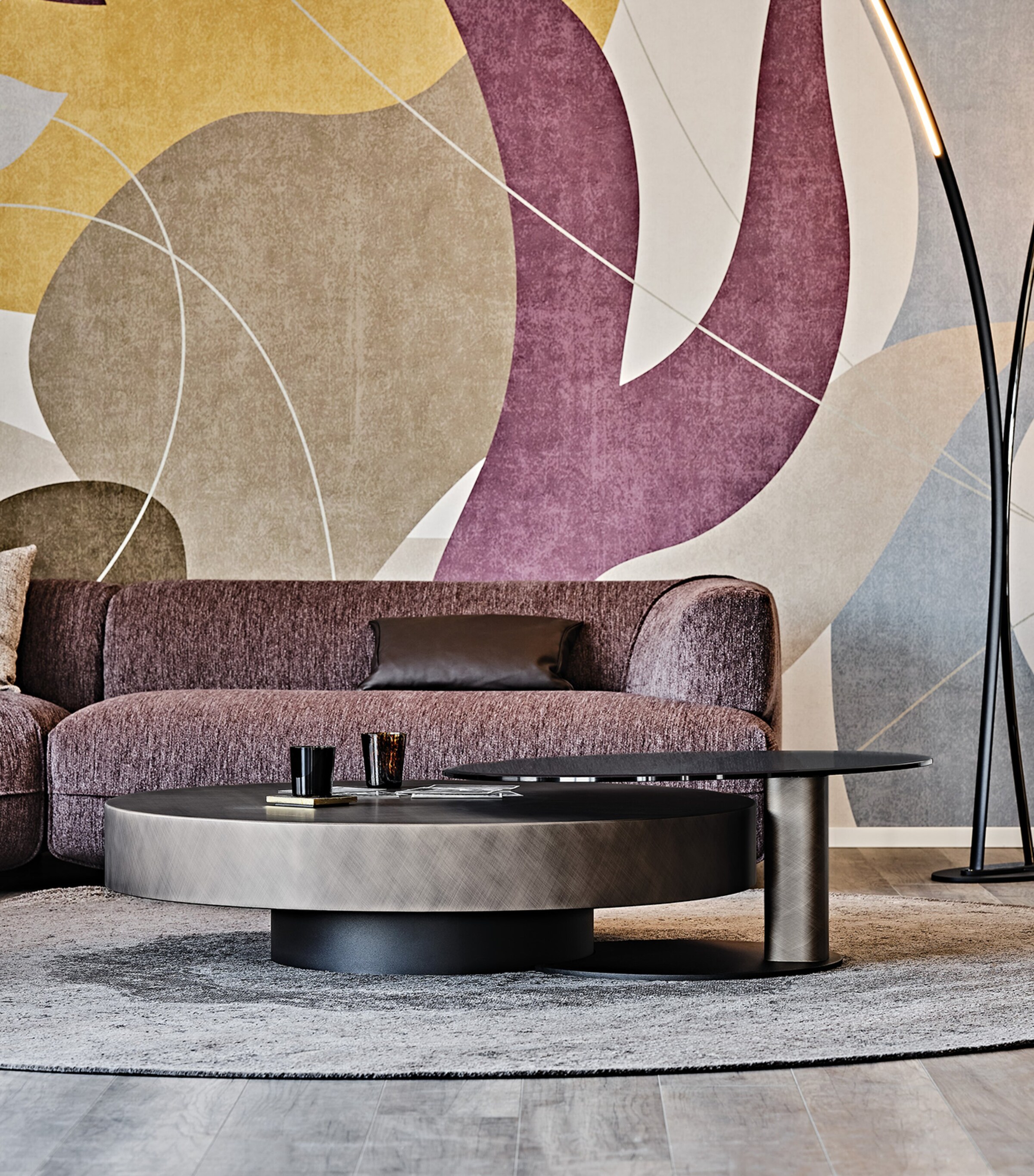 Close-up of round coffee table with floral patterned wall behind