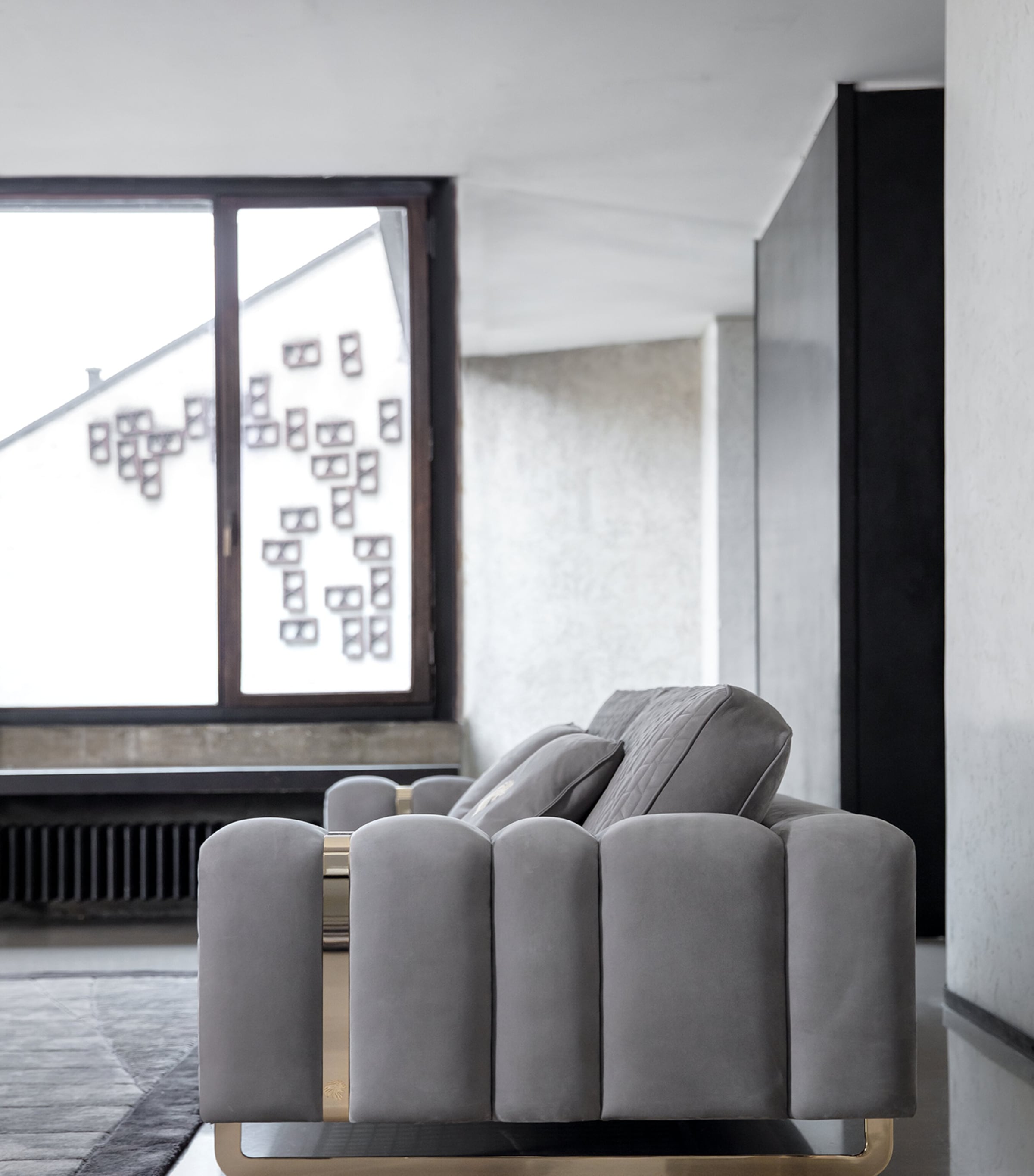 Side view of sofa showing rounded arm and plush cushions